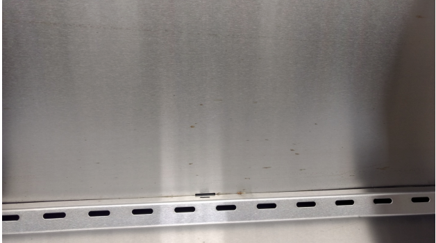 What do I do if small rust or pitting shows up on the stainless steel?